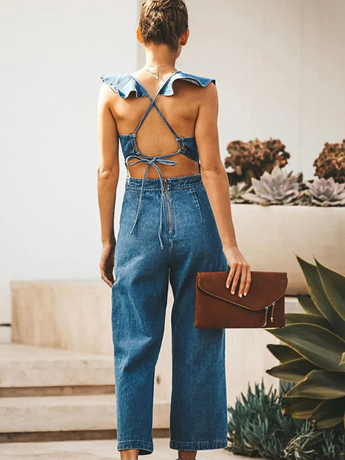 Backless sleeveless denim jumpsuit with ruffled details from Trendsi, featuring a fitted waist and casual denim jeans style.