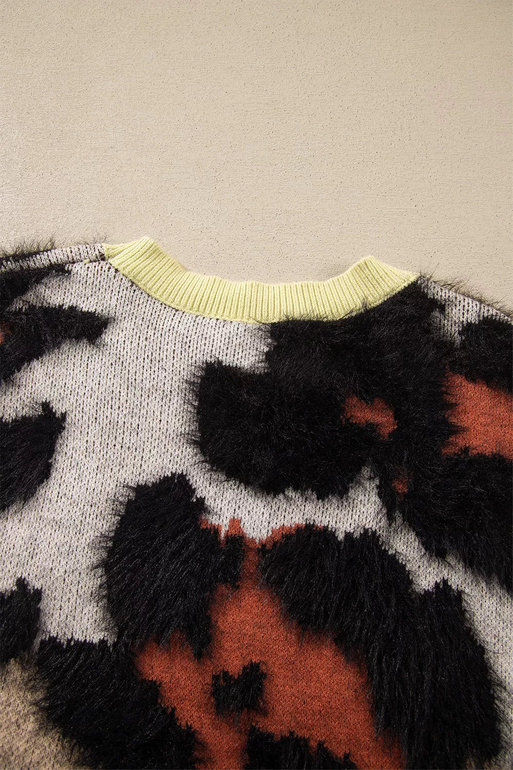 Leopard print drop shoulder long sleeve sweater with round neck from Trendsi, featuring a relaxed fit and cozy knit fabric.