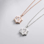 Silver snowflake necklace with diamond pendant, featuring intricate design and sparkling gemstones on a delicate chain.