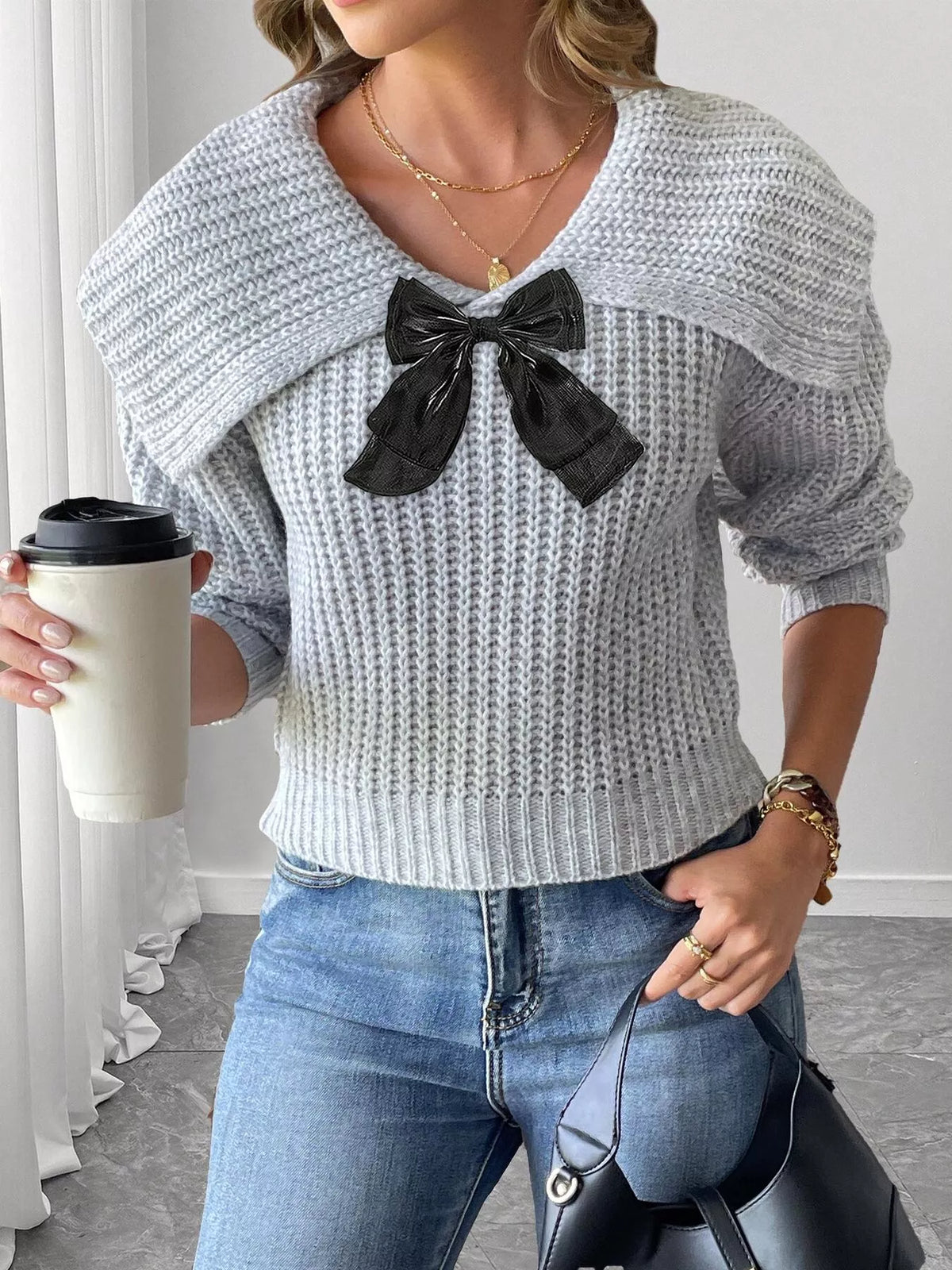 Contrast bow long sleeve sweater paired with a skirt, showcasing trendy knitwear with a bow detail and long sleeves.