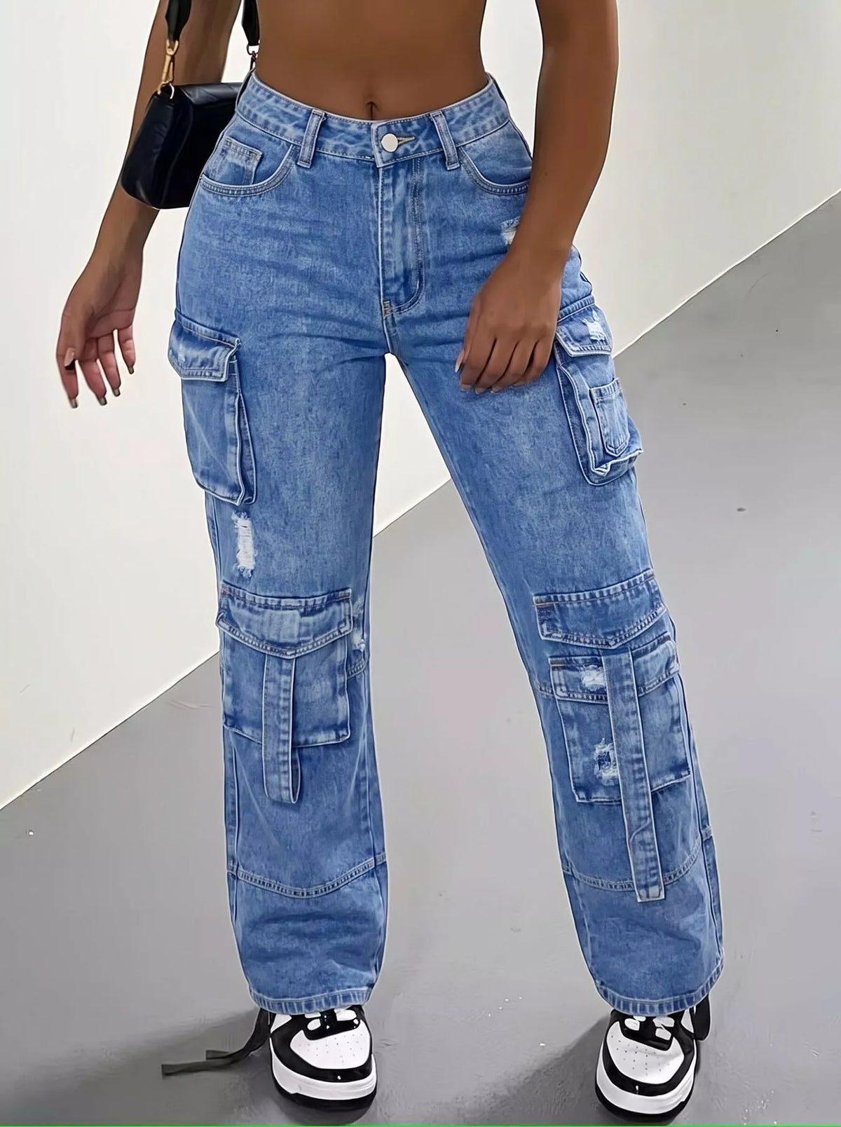 High-waisted distressed cargo jeans by Trendsi, featuring rugged fabric, multiple pockets, and a casual, trendy fit.