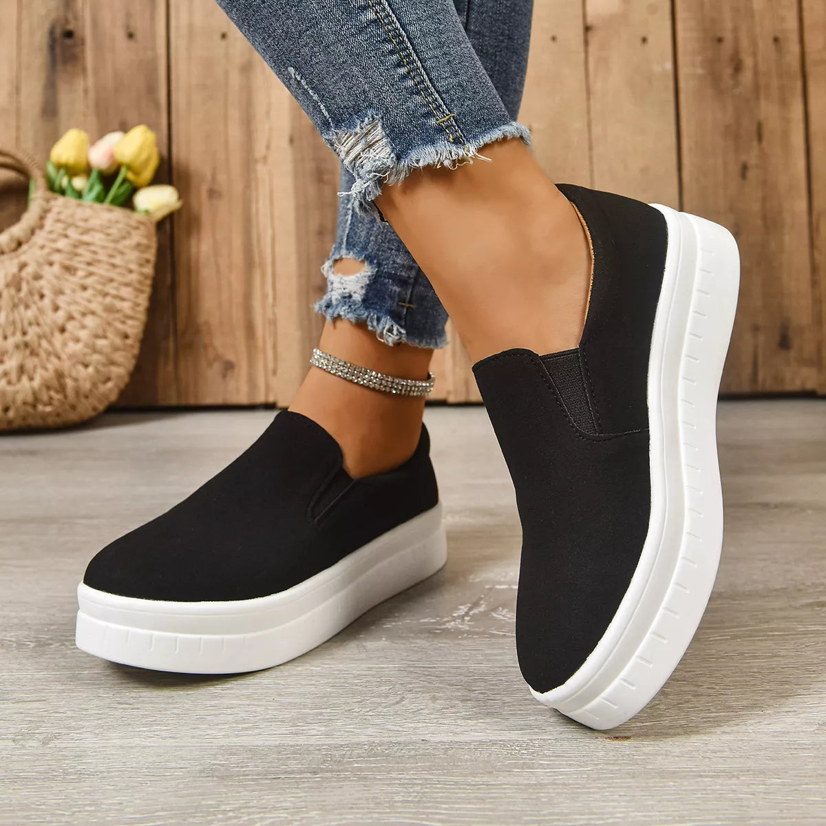 Round toe platform slip-on footwear by Trendsi, featuring a sleek design and comfortable sole, ideal for casual wear.