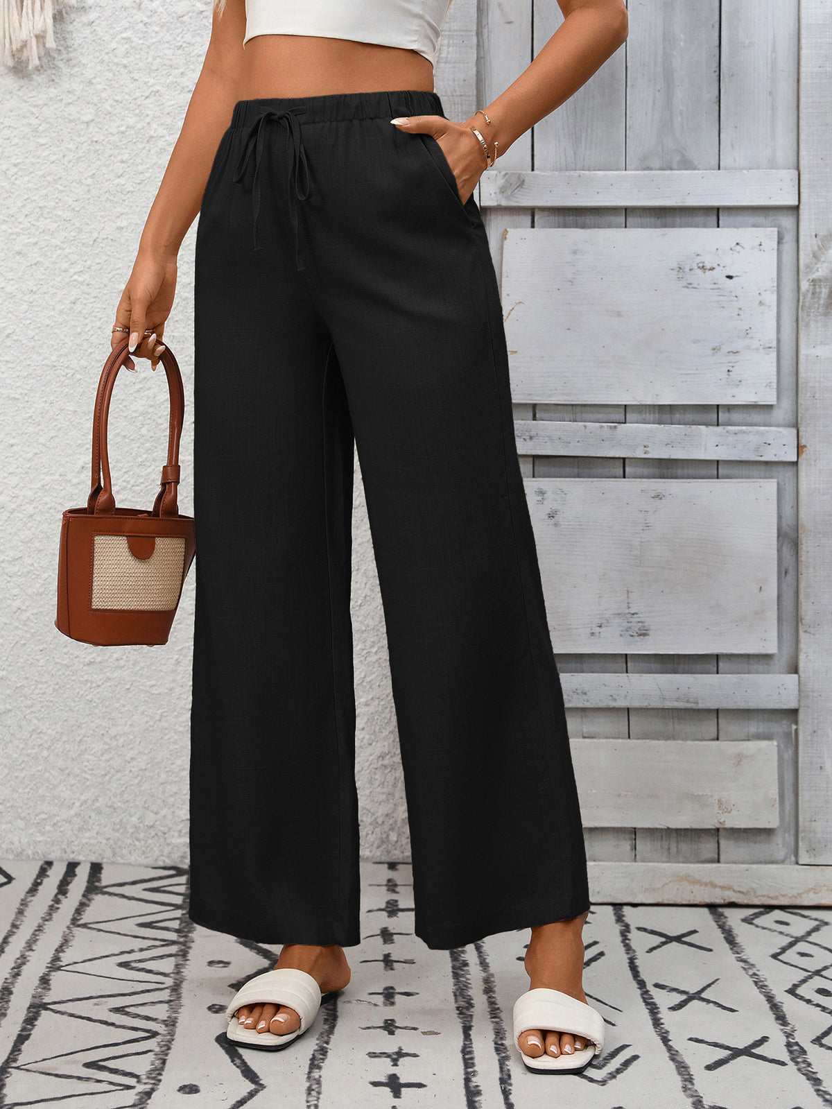 Women's high-waisted wide-leg drawstring pants in soft breathable viscose, featuring a relaxed fit and comfortable waistband.