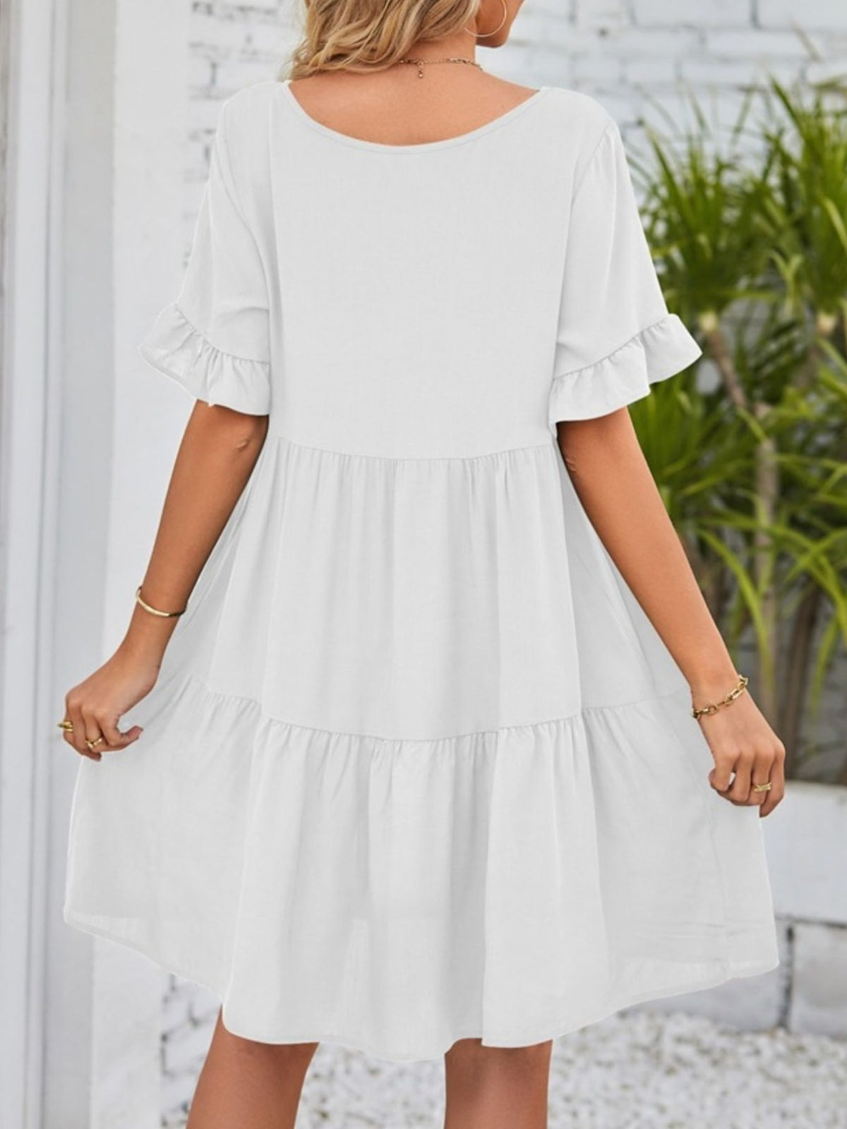 Lightweight rayon mini dress with ruffled sleeves, tiered design, and pockets from Plush Fashion Hub.