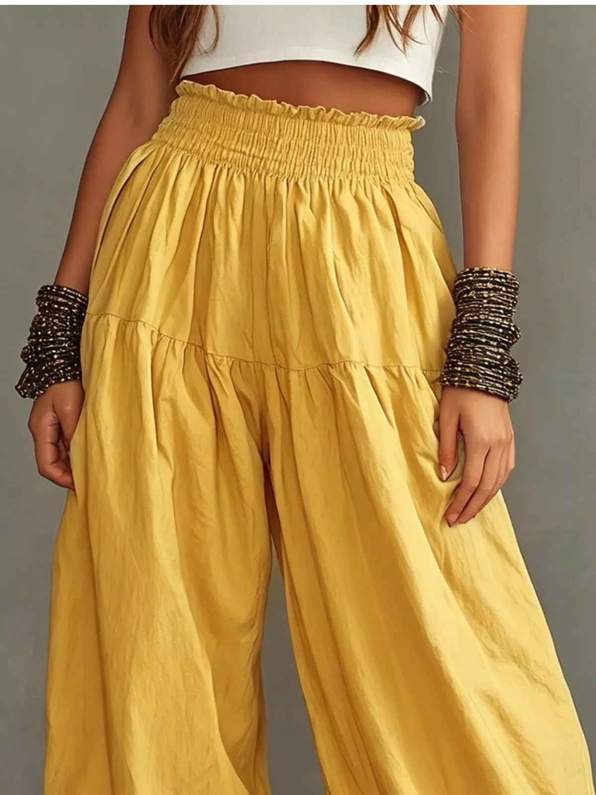 Plus size plush fashion hub wide-leg pants with smocked waist and ruffle hem, featuring a flowy, comfortable fit.