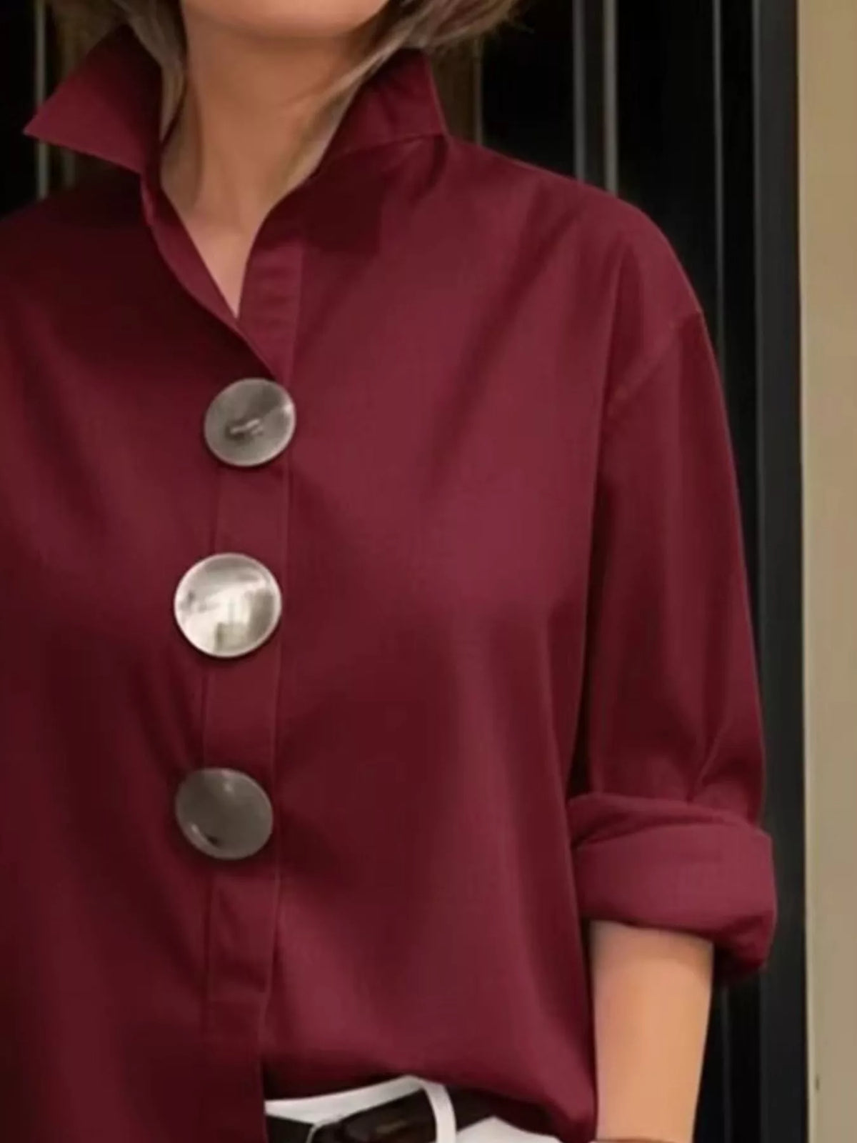 Plus size oversized long sleeve shirt by Trendsi featuring metal buttons and a relaxed fit, shown in a full-size view.