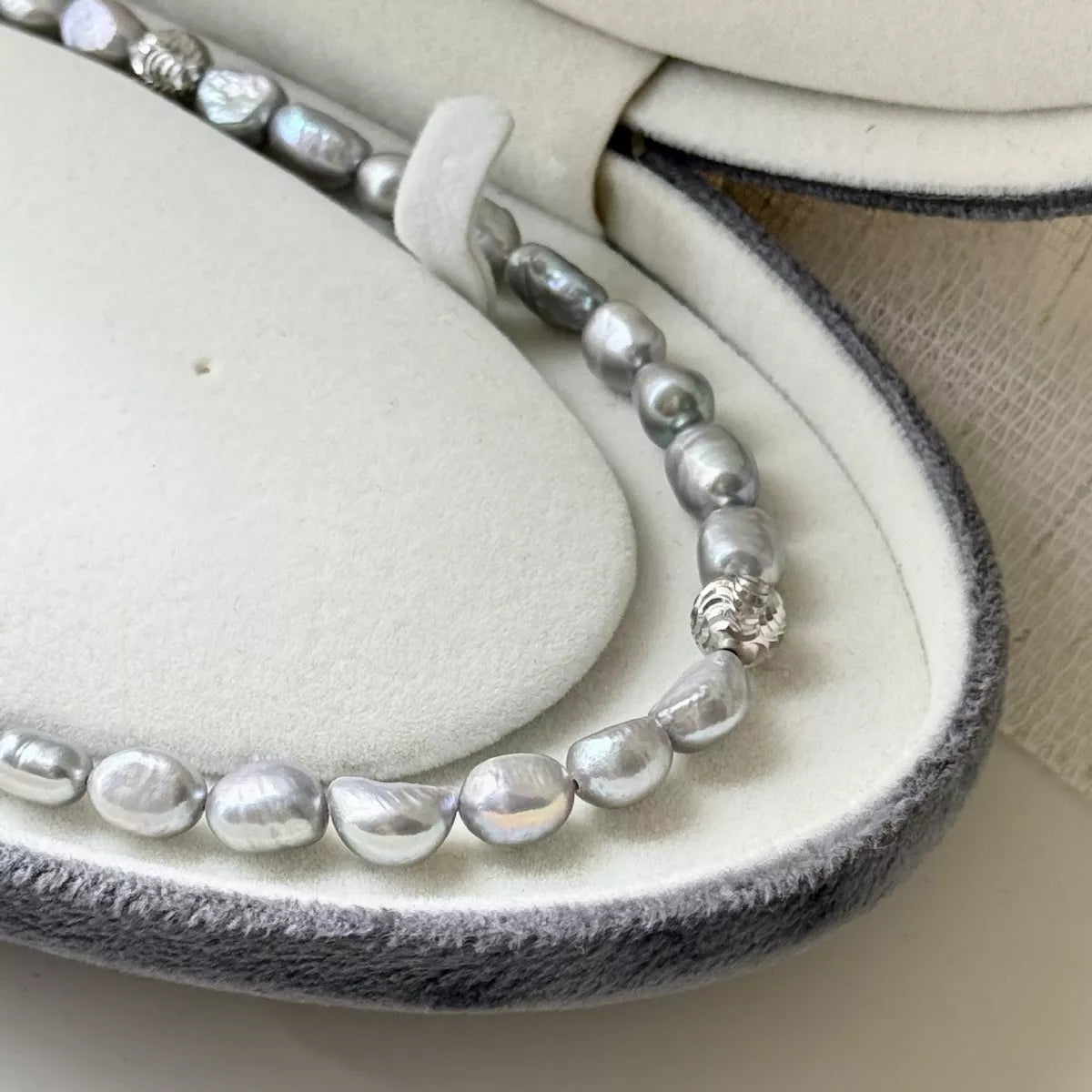 Pearl choker necklace by Plush Fashion Hub featuring a string of elegant white pearls on a delicate necklace.