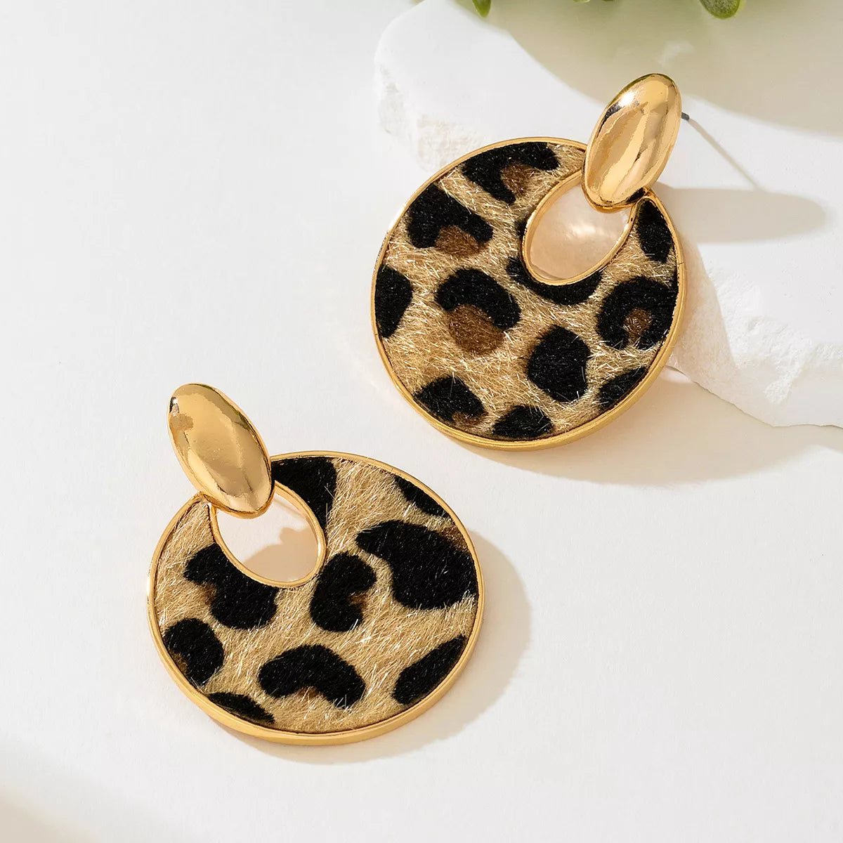Leopard circle dangle earrings from Plush Fashion Hub featuring gold-toned hoops with leopard print accents.