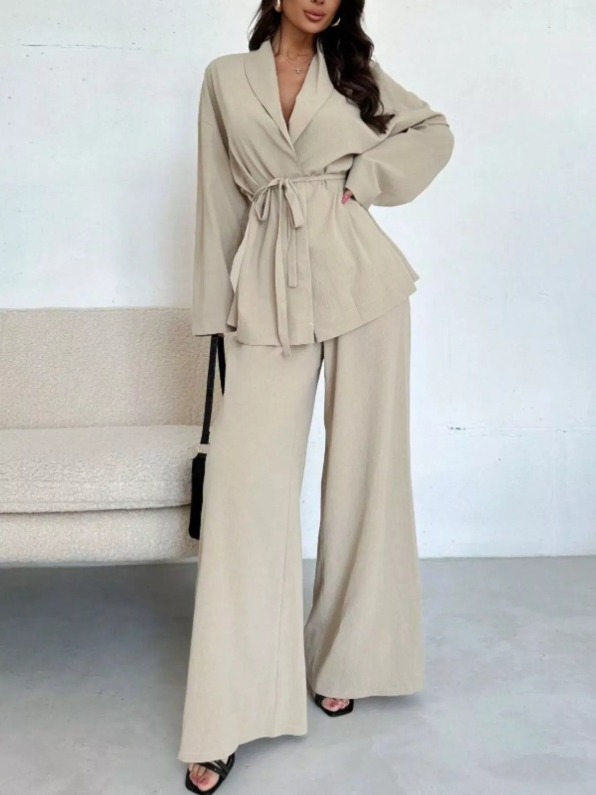 Textured tie waist top and wide-leg pants set for women from Trendsi, featuring a stylish, coordinated outfit with a modern look.