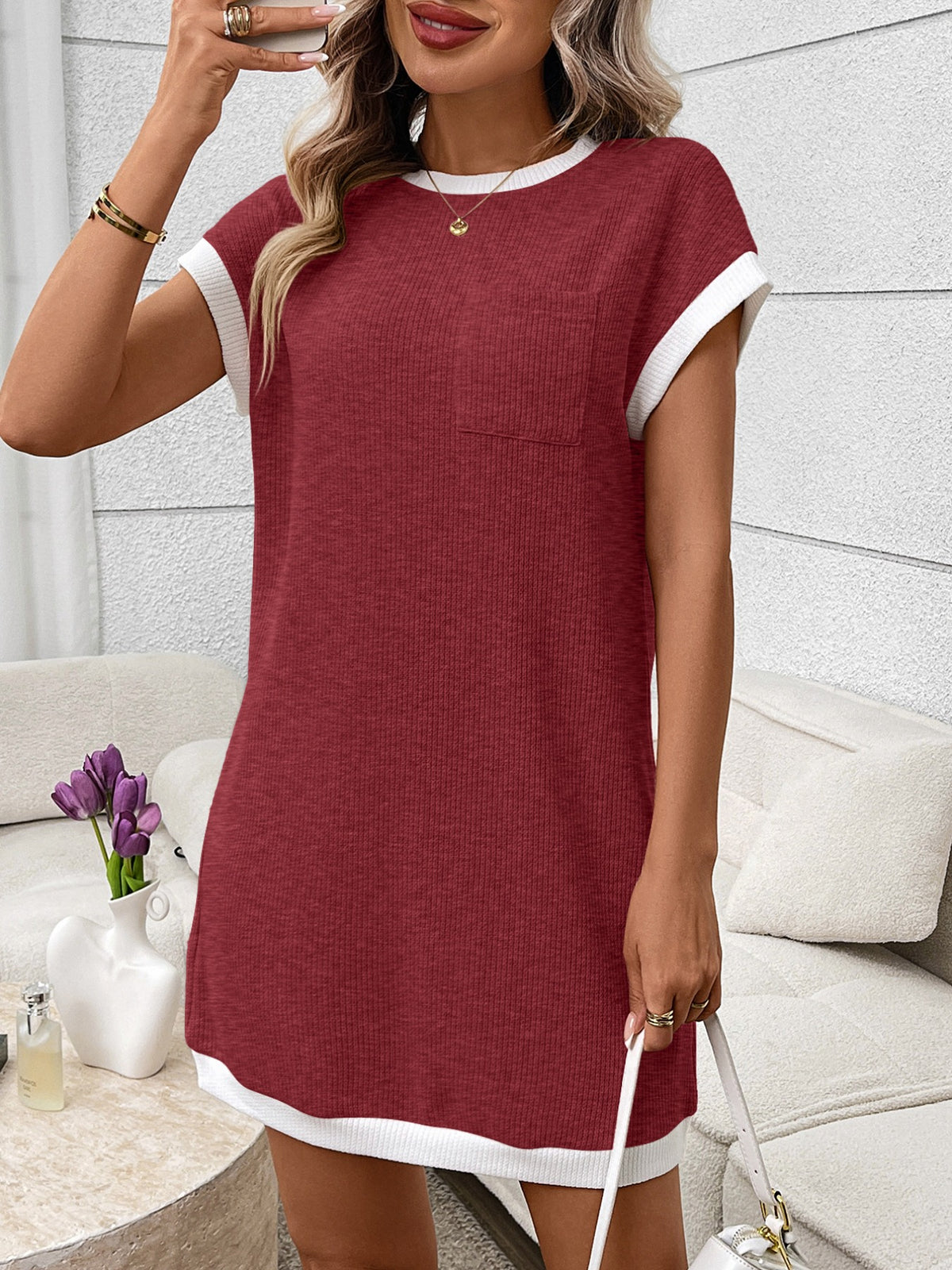 Ribbed knit mini dress with contrast trim and functional pocket by Plush Fashion Hub, featuring a fitted silhouette and stylish details.