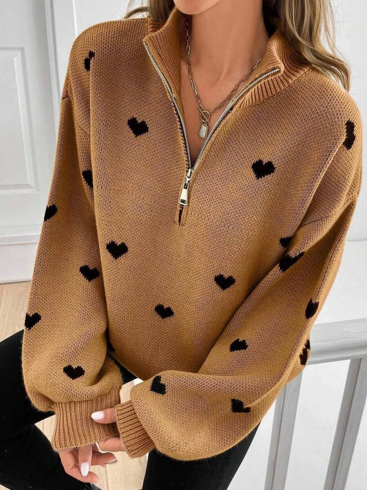 Plus size full heart half-zip long sleeve sweater by Trendsi, featuring a cozy design and a prominent heart pattern on the front.