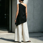 Women's one-shoulder asymmetric sleeveless top by Plush Fashion Hub, shown in a stylish design with a unique shoulder cutout.