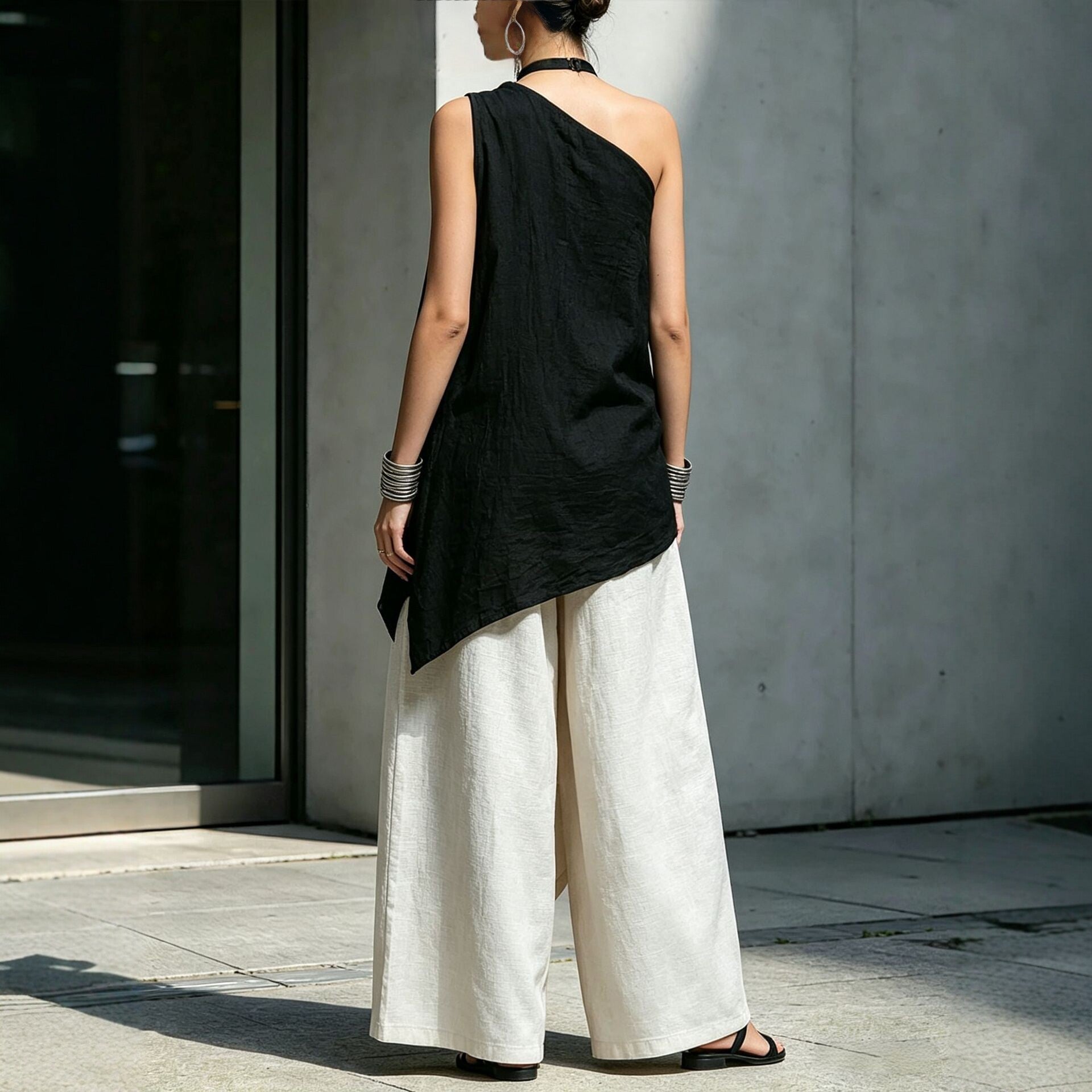 Women's one-shoulder asymmetric sleeveless top by Plush Fashion Hub, shown in a stylish design with a unique shoulder cutout.