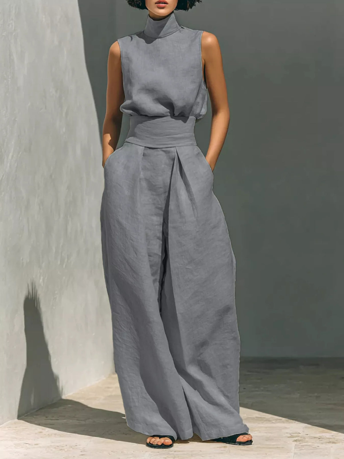 Plus size sleeveless wide-leg jumpsuit with smocked waist, stylish full-length jumpsuit by Trendsi, shown in the image.