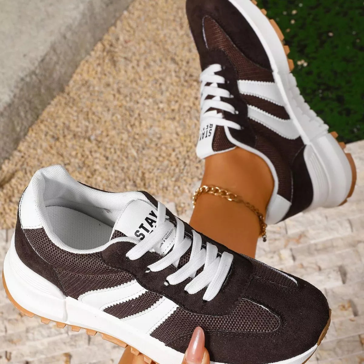 Women's round toe lace-up sneakers by Trendsi featuring stylish design and white laces on a clean background.