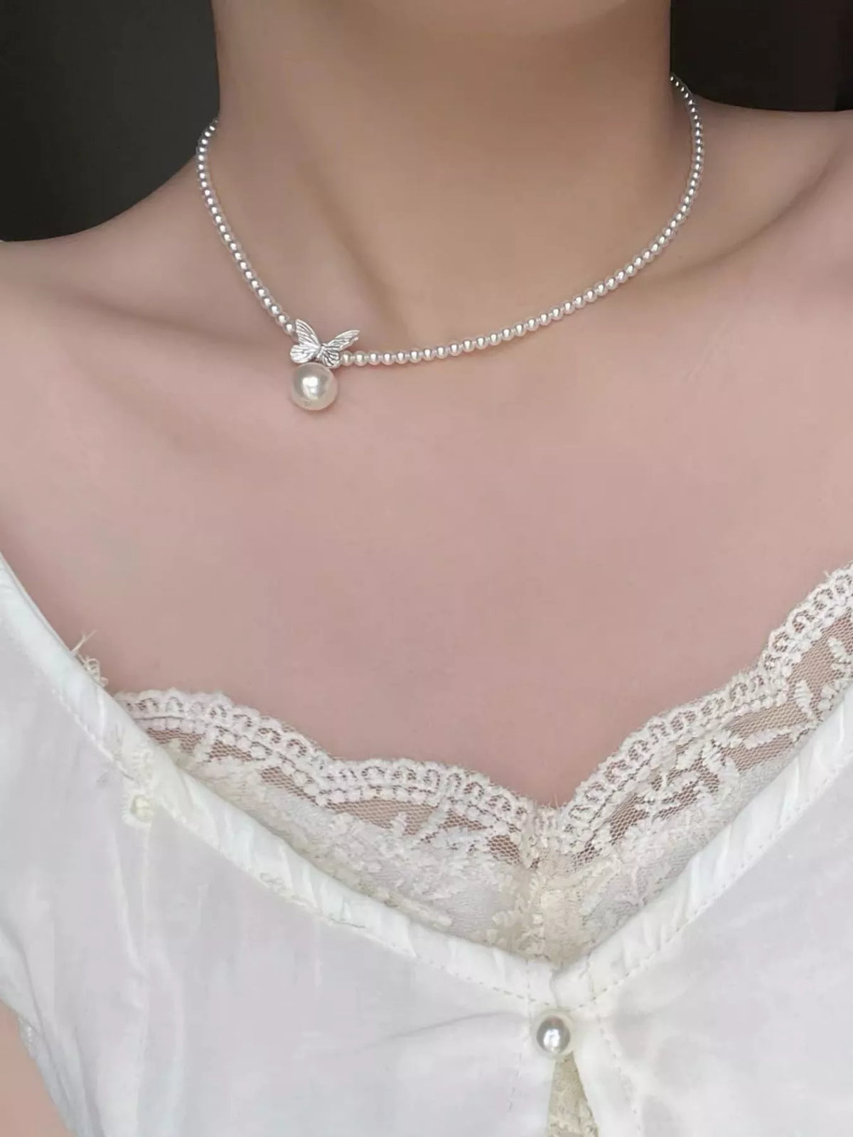 Pearl butterfly pendant necklace by Plush Fashion Hub featuring a delicate pearl butterfly charm on a silver chain.