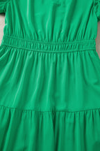 Women's floral maxi dress with ruffled tiers and puff sleeves, elegant long dress by Trendsi, featuring a flowing design.