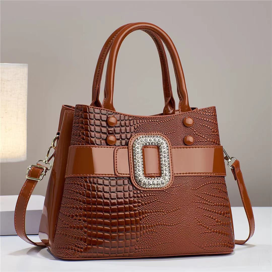 Lizard-patterned mini bucket crossbody bag with zipper from Plush Fashion Hub, featuring a compact design and adjustable strap.