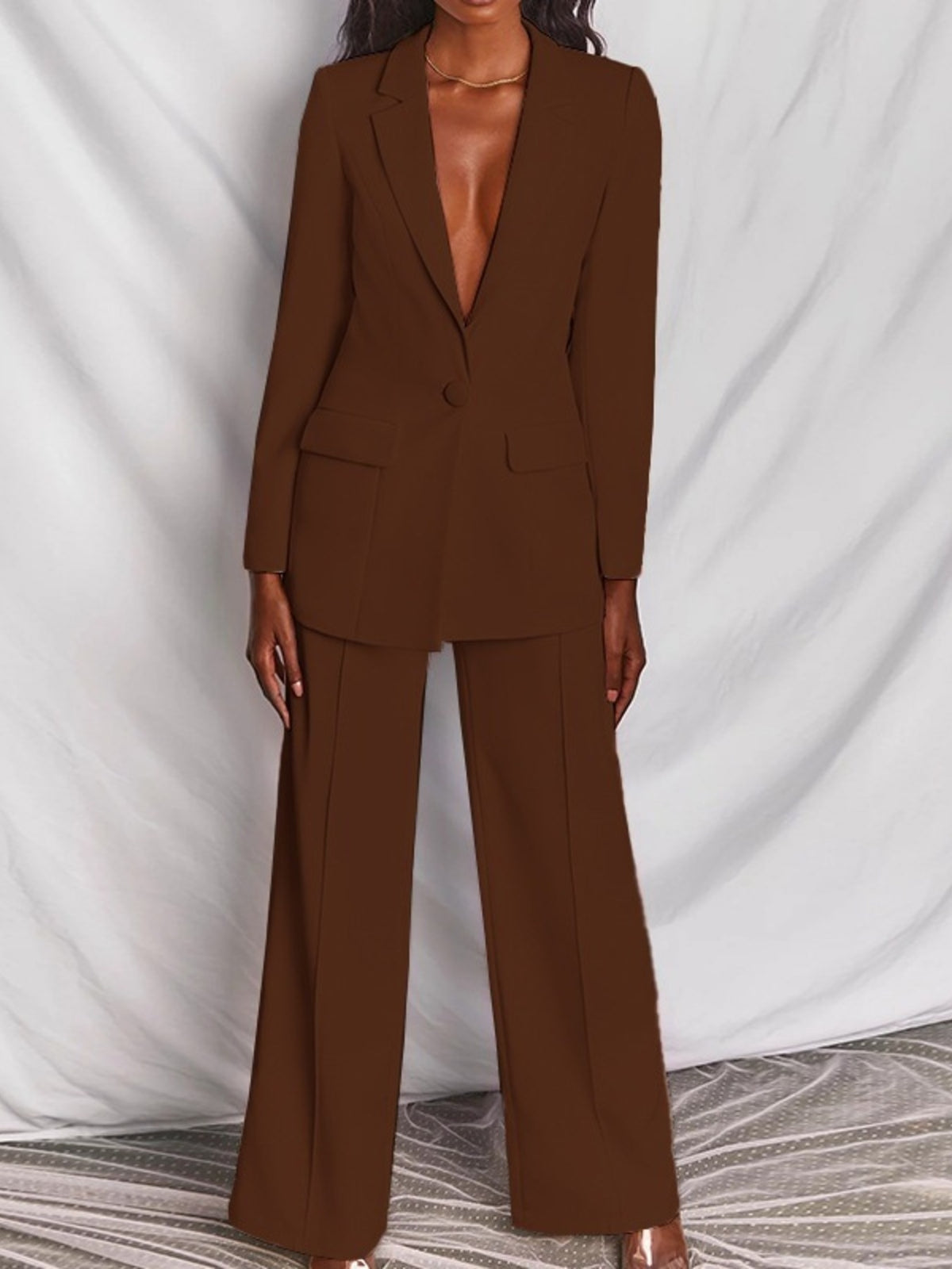 Plus size blazer and wide-leg pants matching set by Trendsi, featuring a one-button blazer and stylish wide-leg trousers.