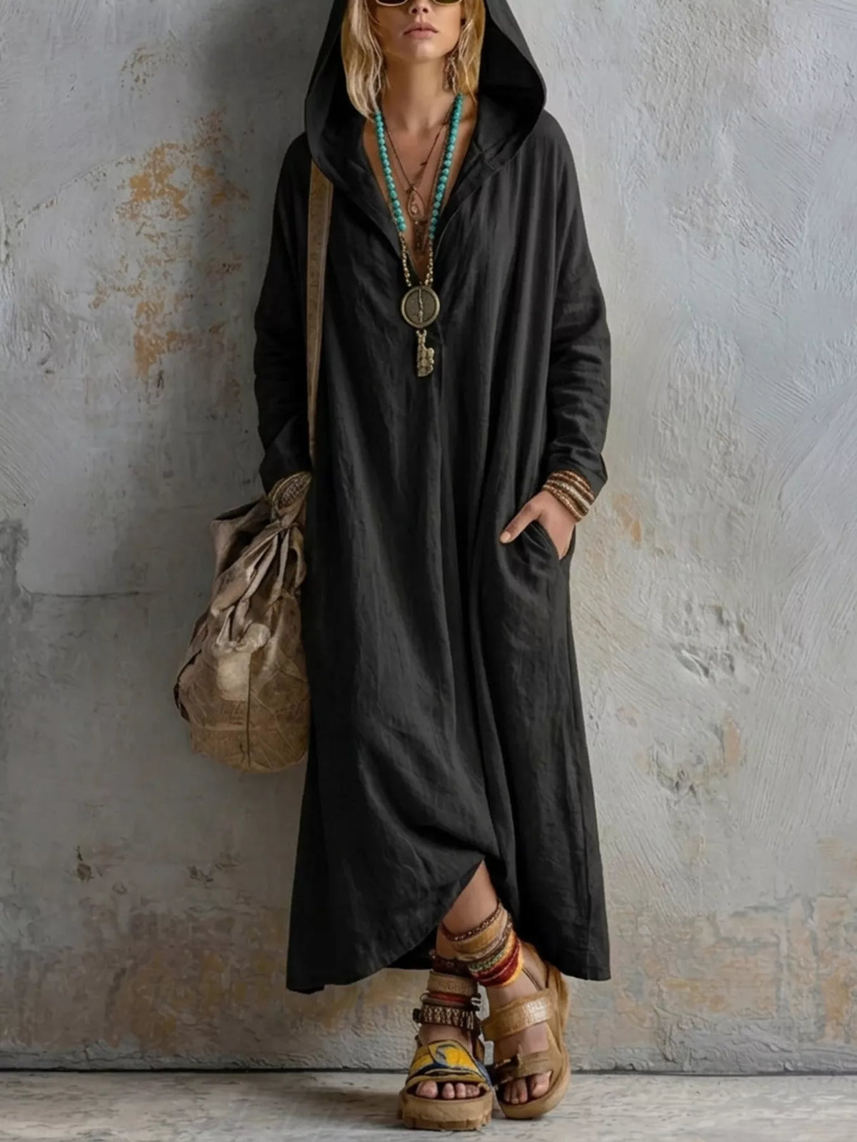 Women's long sleeve hooded midi dress with pockets by Trendsi, featuring a comfortable fit and casual style in soft fabric.