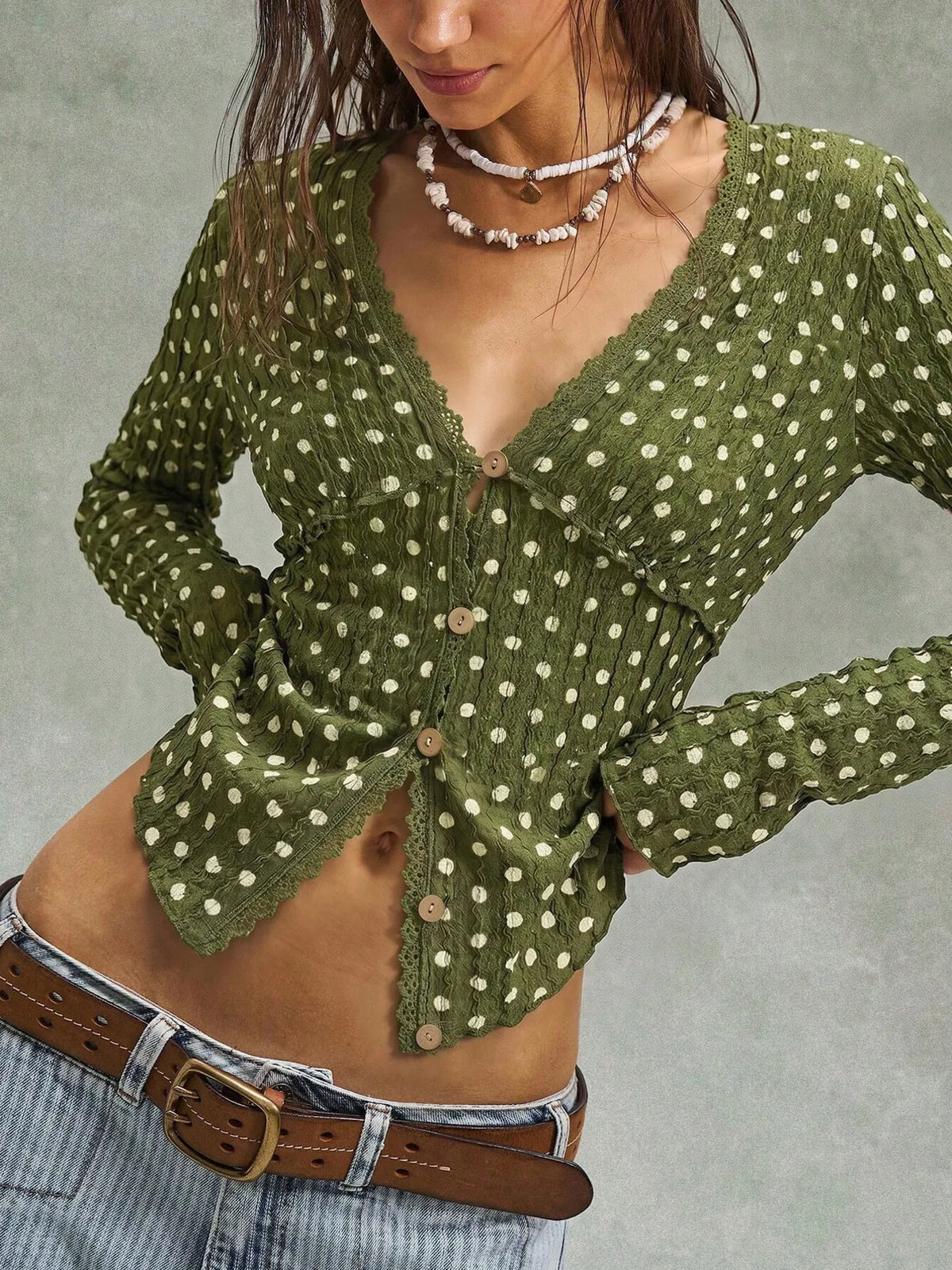 Women’s long sleeve textured polka dot blouse by Trendsi, featuring a button-down front and classic pattern.