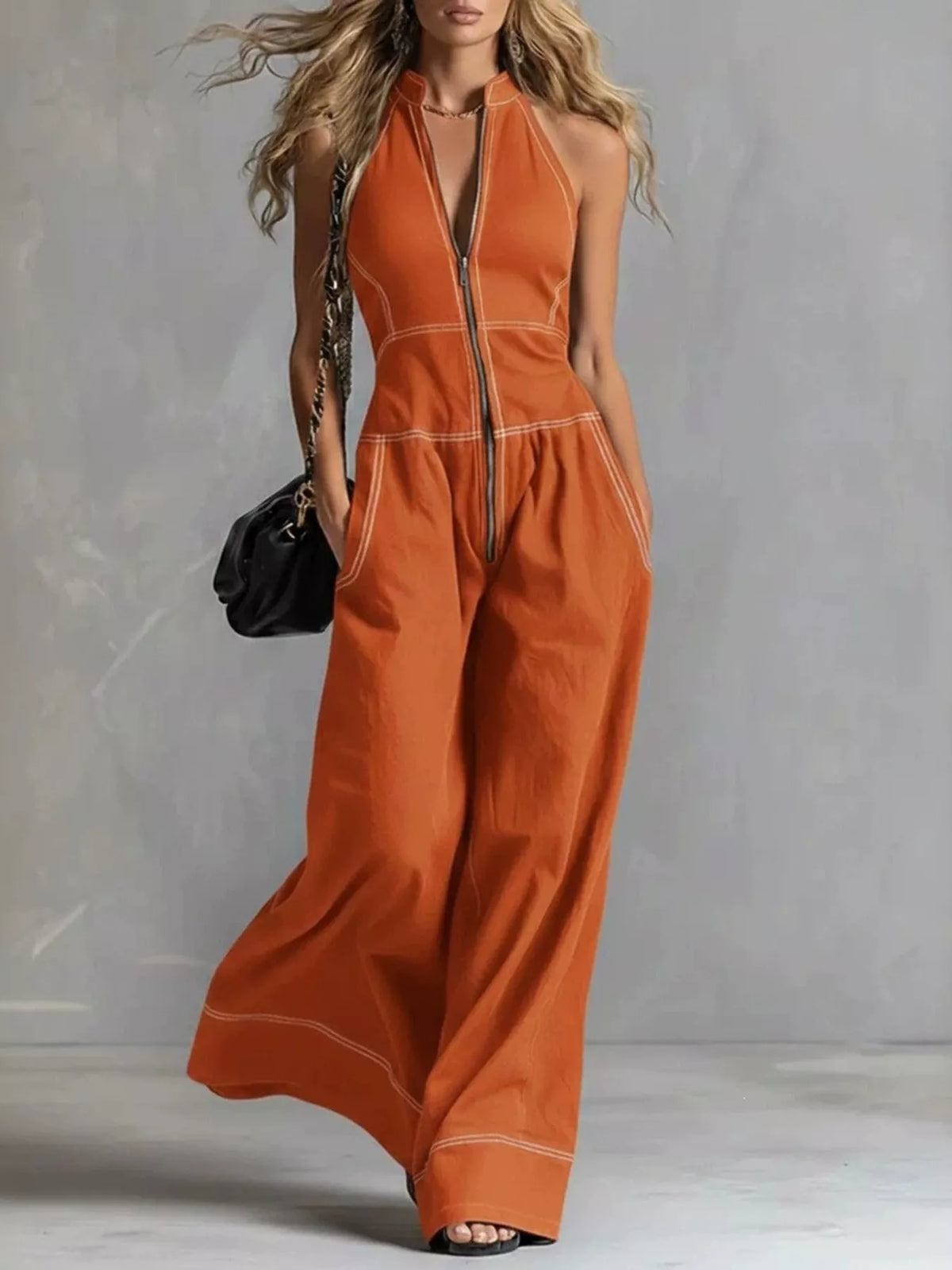 Sleeveless wide-leg jumpsuit with zip front from Trendsi, featuring a modern, stylish design and a comfortable fit.