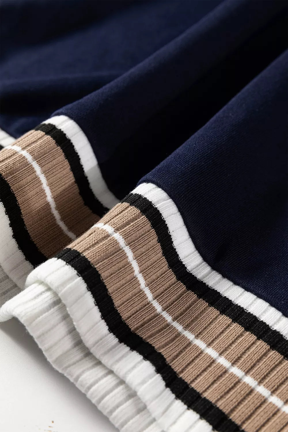 Contrast striped trim V-neck sweatshirt by Trendsi featuring a relaxed fit, soft fabric, and stylish striped detailing at the neckline.