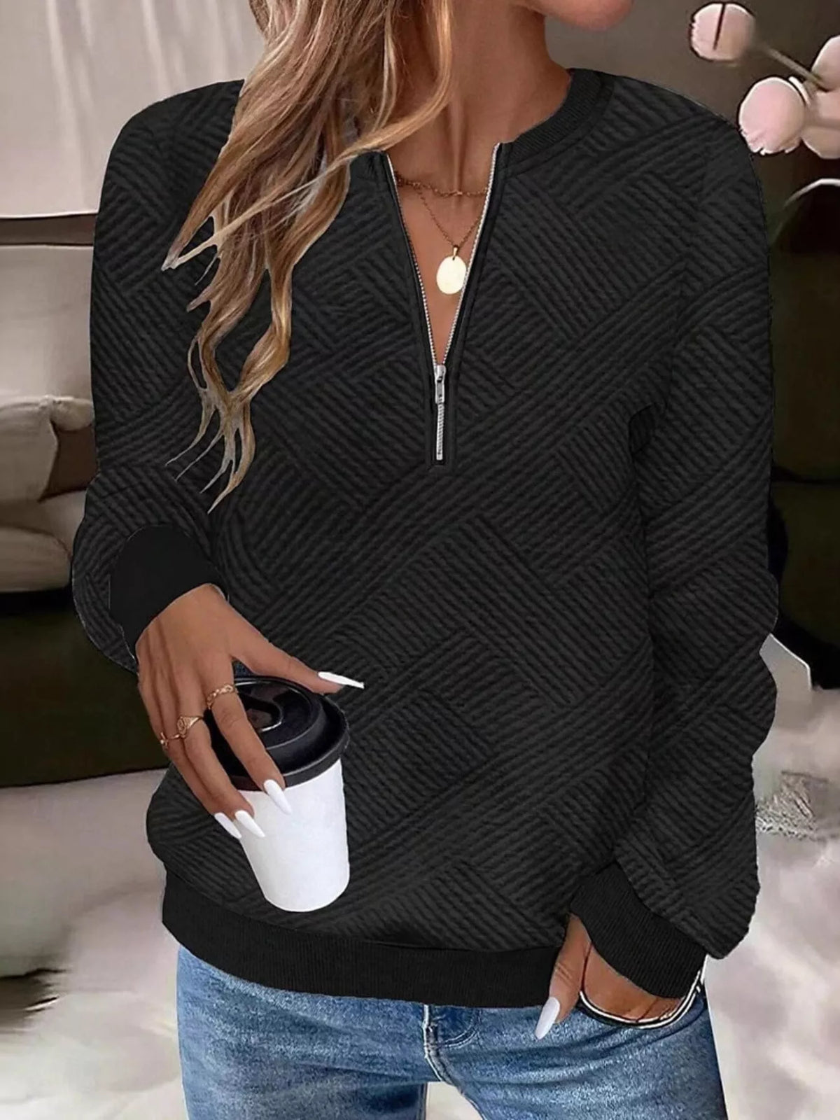 Textured women's quarter-zip sweatshirt from Trendsi, showing the fabric detail and fit on a model, in a casual style.