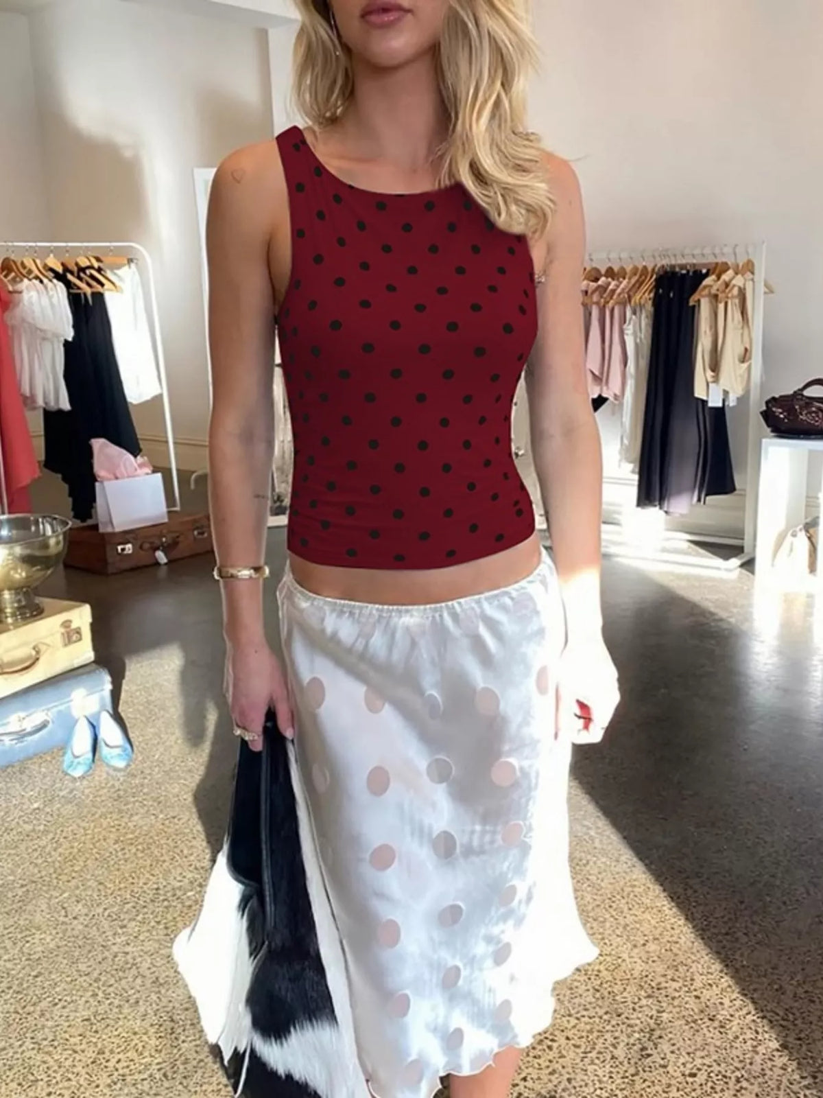 Polka dot tank top from Plush Fashion Hub featuring a sleeveless design and playful black and white polka dot pattern.