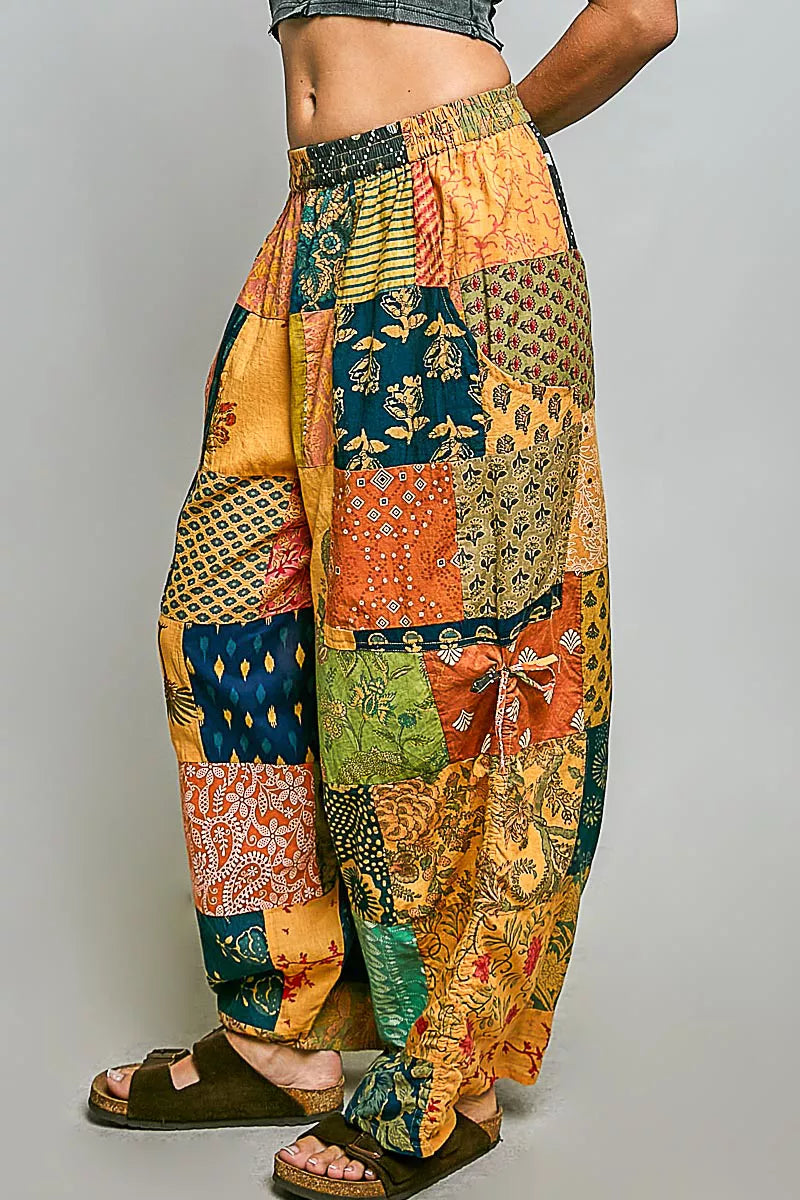 Cotton printed patchwork wide-leg pants with side drawstring, featuring colorful patterns and relaxed fit from Plush Fashion Hub.