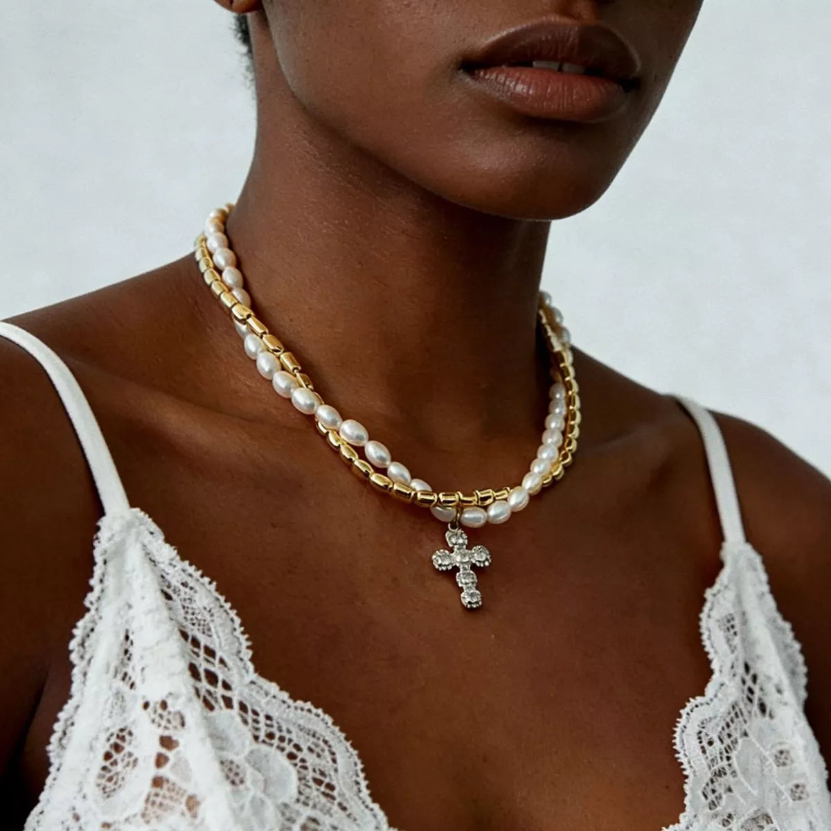 Elegant pearl alloy necklace with rhinestone cross pendant, featuring a stylish design and intricate details.