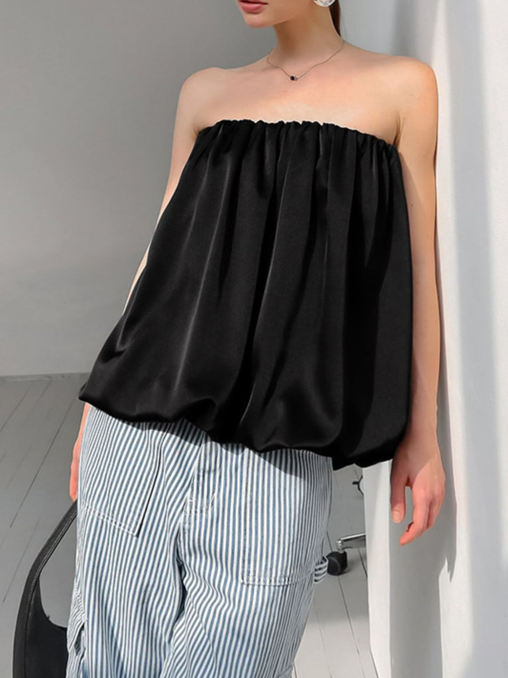 Women’s strapless bubble hem tube top by Trendsi, sleek and trendy minimalist crop top with a fitted design and bubble hem detail.
