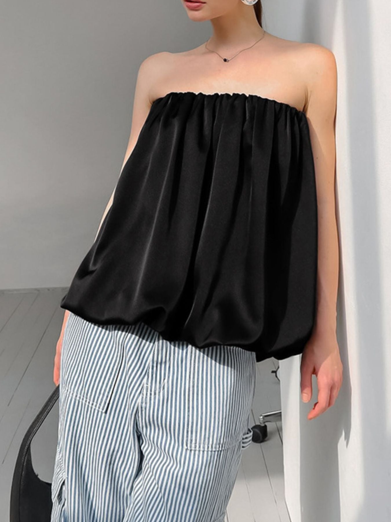 Women’s strapless bubble hem tube top by Trendsi, sleek and trendy minimalist crop top with a fitted design and bubble hem detail.