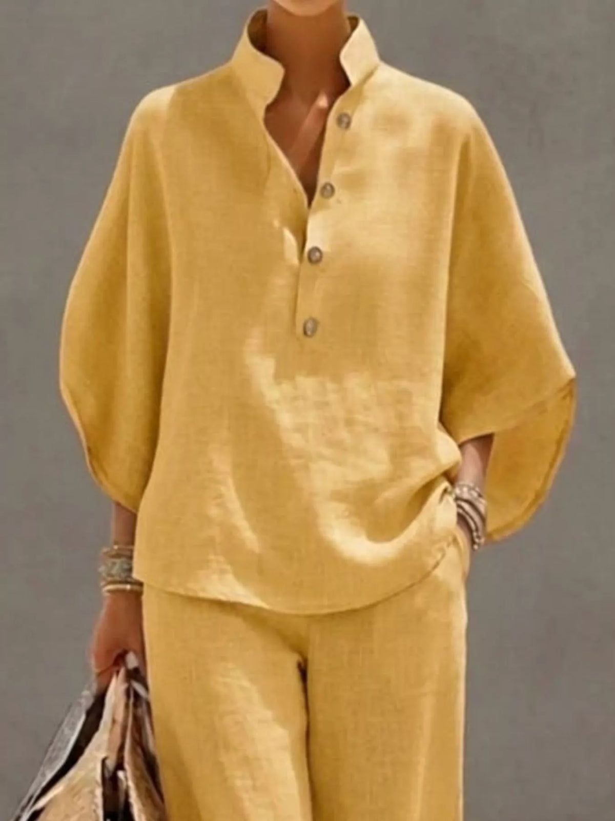 Plus size women's two-piece set with button-detail 3/4 sleeve top and matching pants by Plush Fashion Hub.