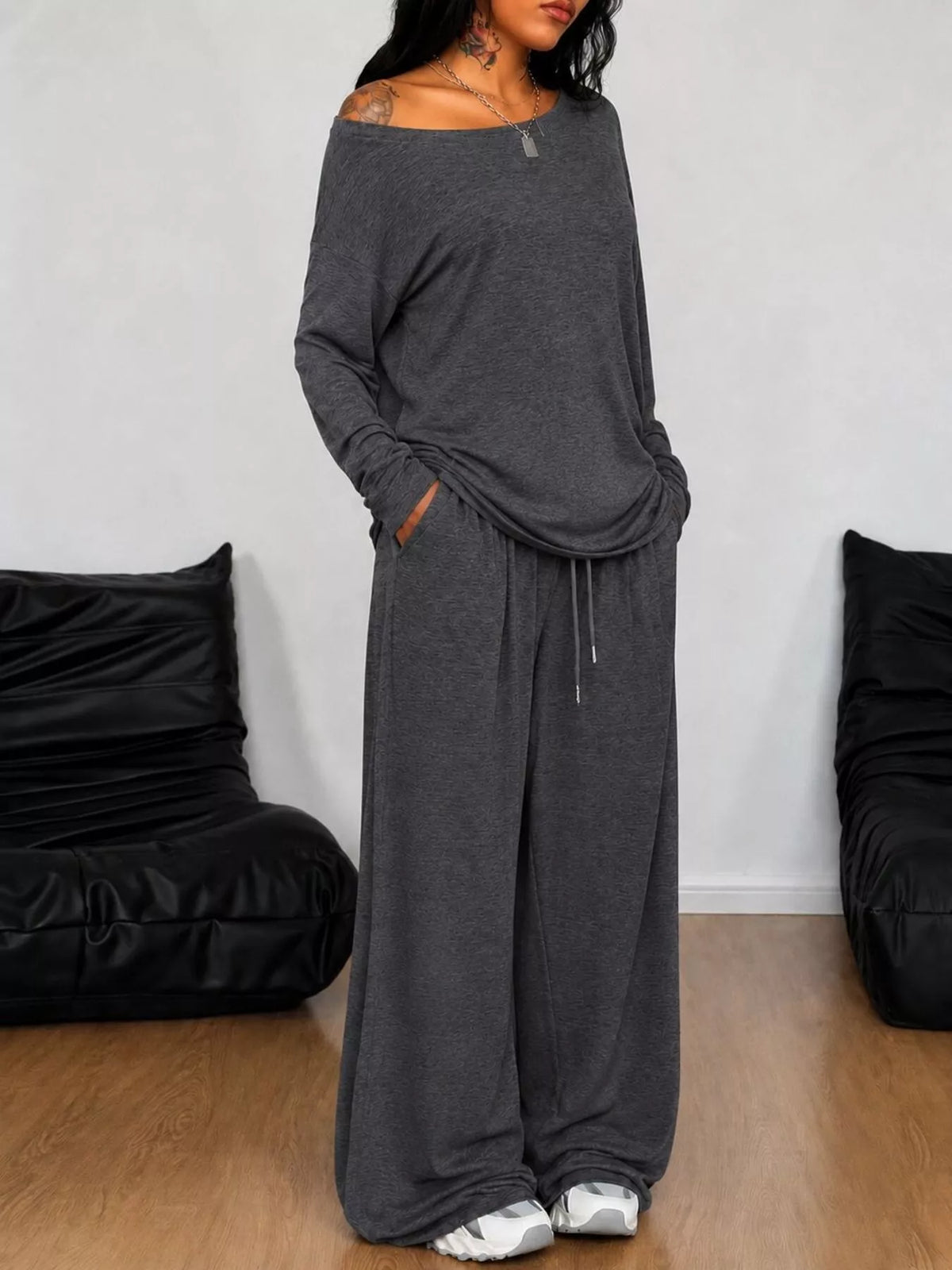 Plus size loose fit one-shoulder t-shirt and pants set by Trendsi, stylish matching set with relaxed fit and modern design.