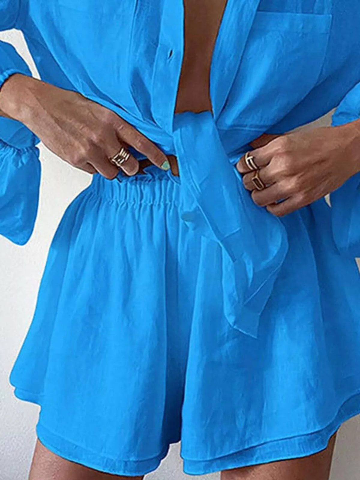 Plush Fashion Hub two-piece set with a long sleeve button-up shirt and matching shorts, made from soft plush fabric.