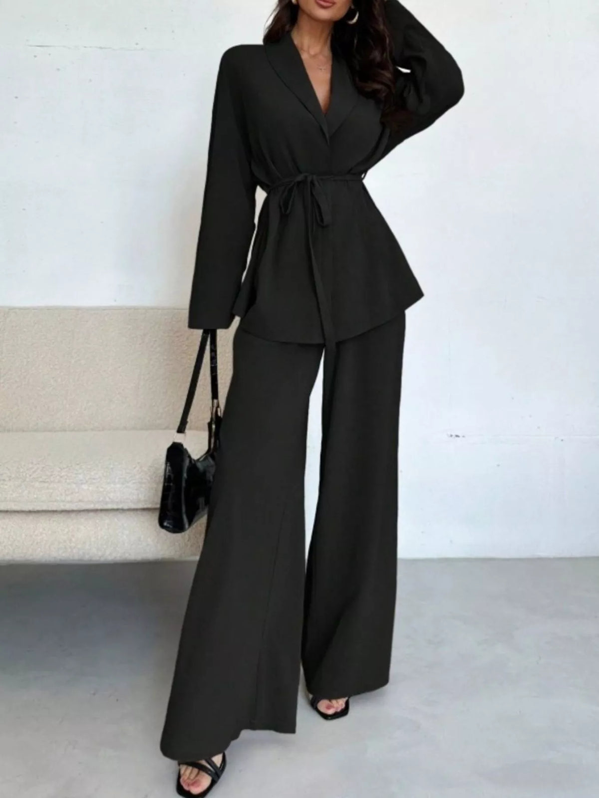 Textured tie waist top and wide-leg pants set for women from Trendsi, shown on a model, featuring a stylish coordinated outfit.
