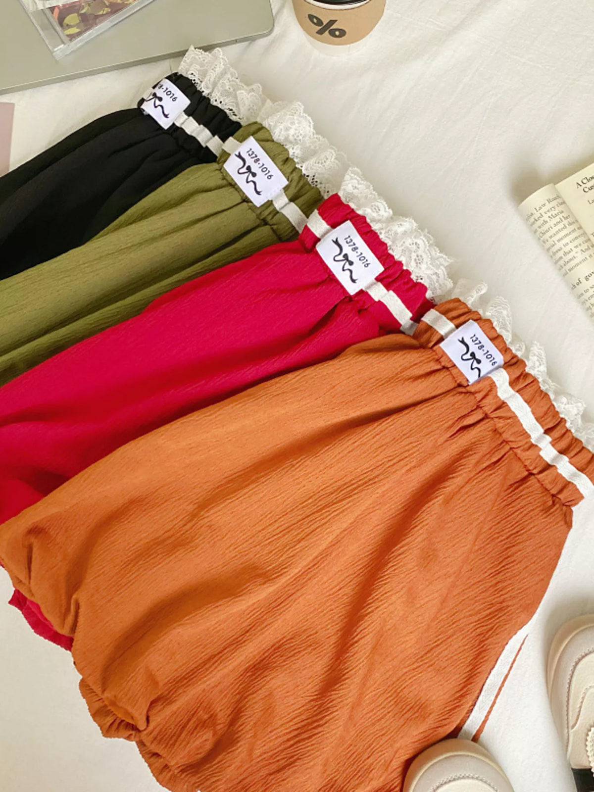Lace trim elastic waist mini skirt from Plush Fashion Hub, featuring a fitted style and delicate lace detail at the hem.