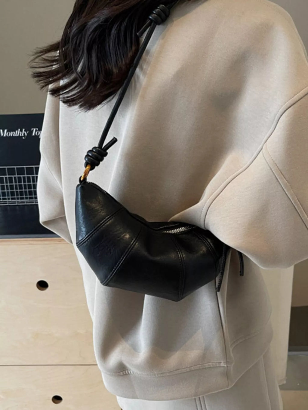 Croissant-shaped crossbody bag by Trendsi with a soft, pastry-inspired design and adjustable strap, perfect for casual wear.