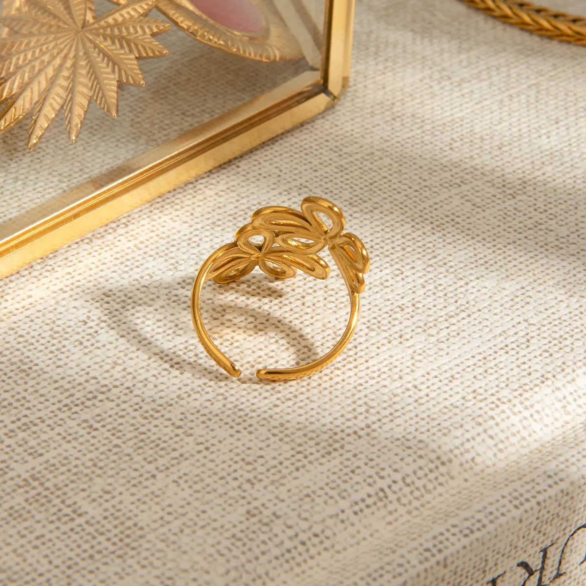 Stainless steel flower ring featuring a detailed floral design, crafted by Plush Fashion Hub, on a white background.