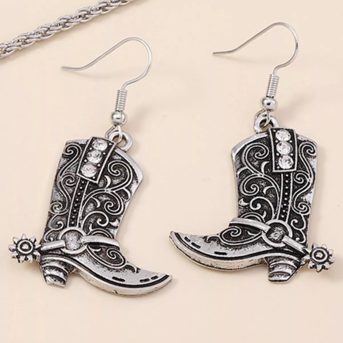 Vintage Western cowboy boot dangle earrings featuring detailed leather and metal accents, perfect for western-inspired fashion.