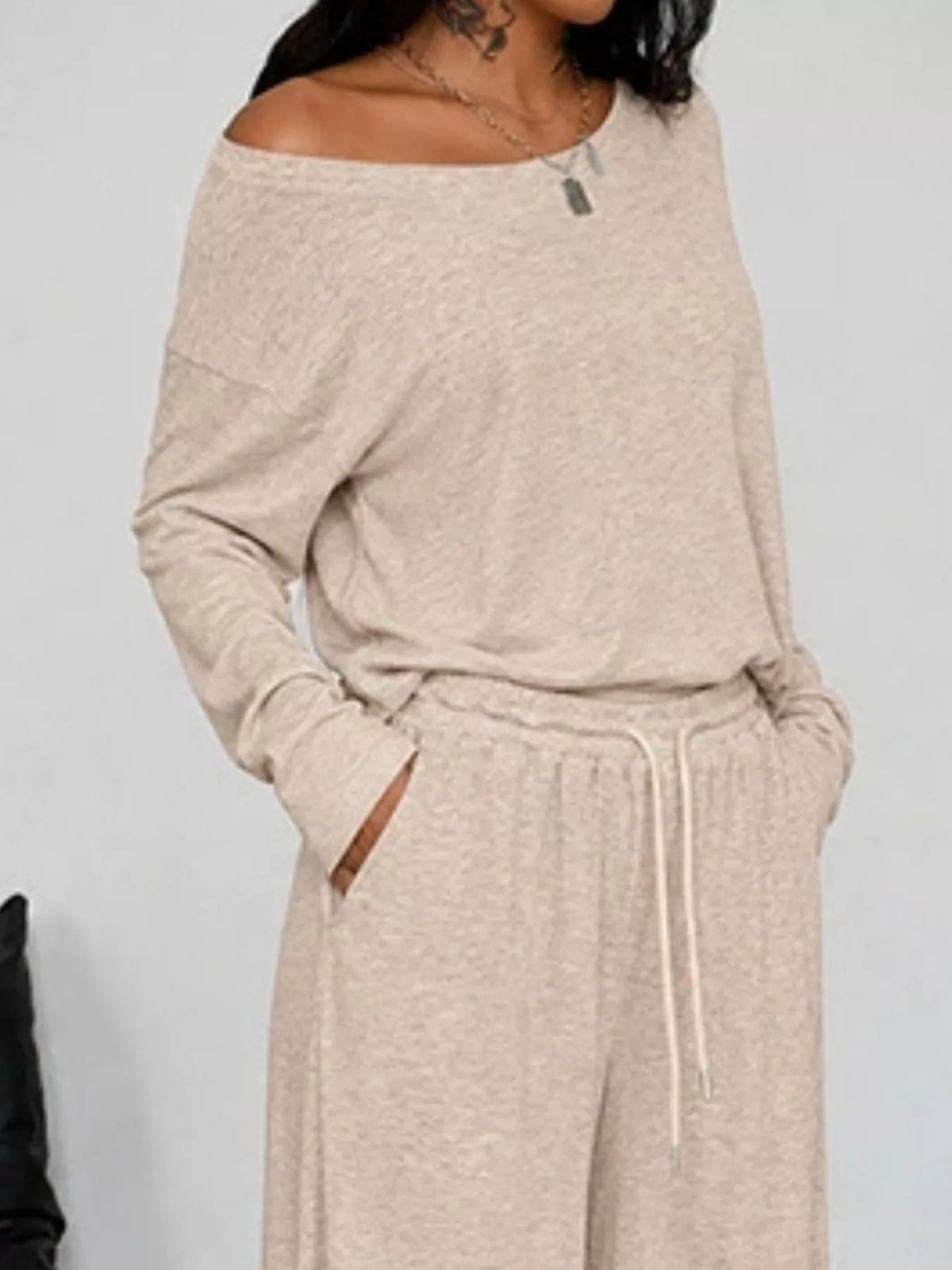 Plus size loose fit one-shoulder T-shirt and pants set by Trendsi, featuring a comfortable, stylish matching outfit.