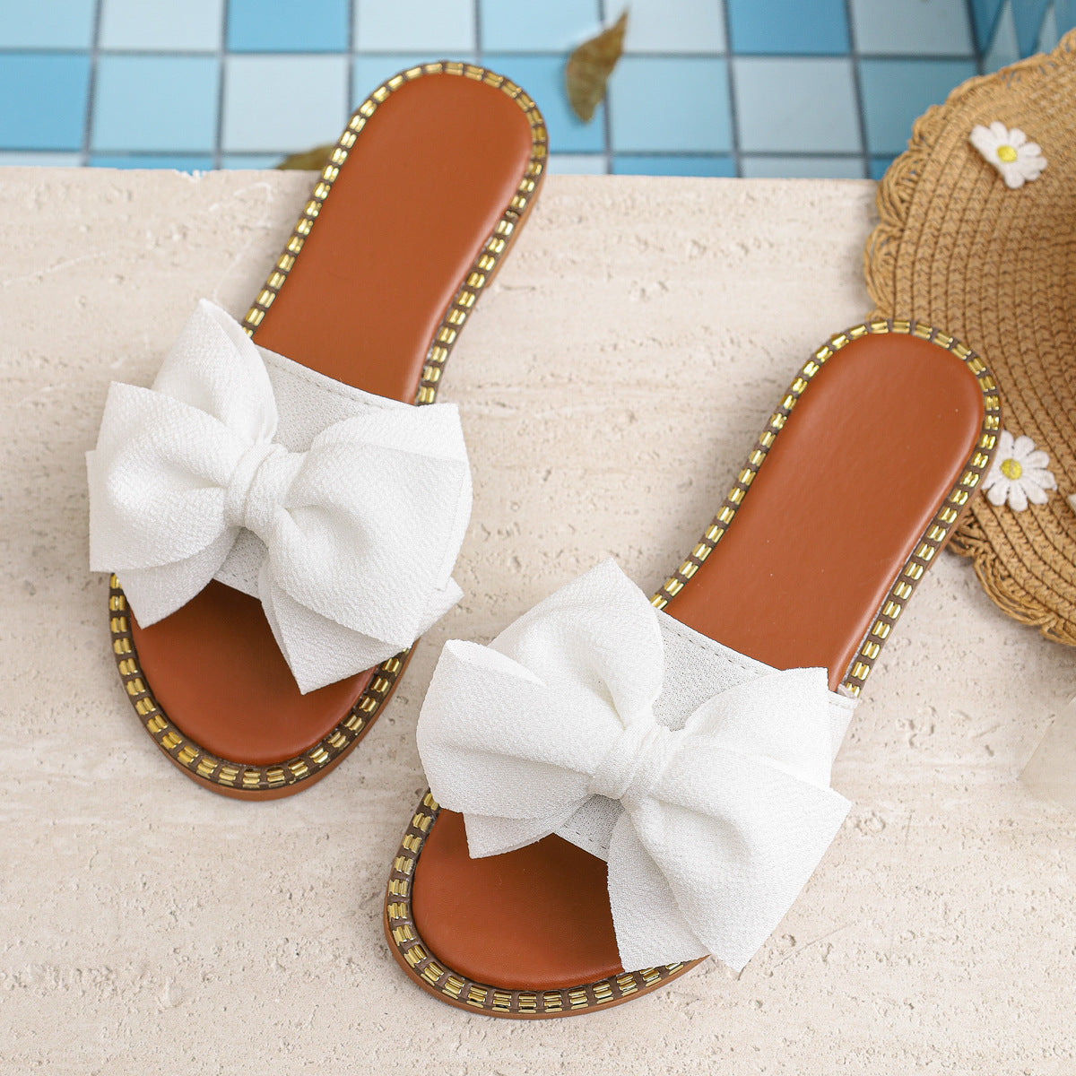 Plush Fashion Hub bowknot embellished flat sandals with stylish straps, perfect for casual summer wear.