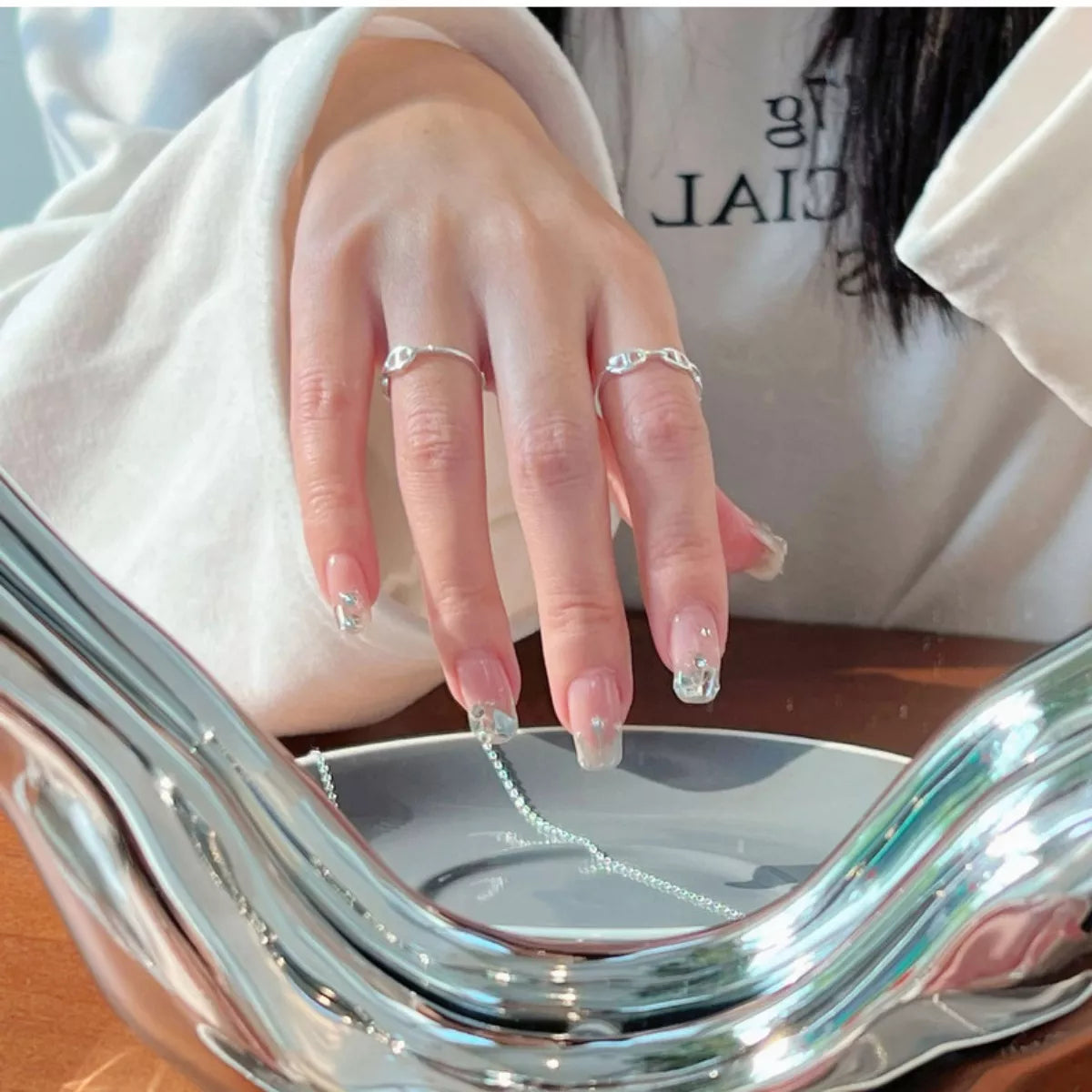 Sterling silver geometric ring with modern design, featuring clean lines and a polished finish, ideal for stylish jewelry collection.