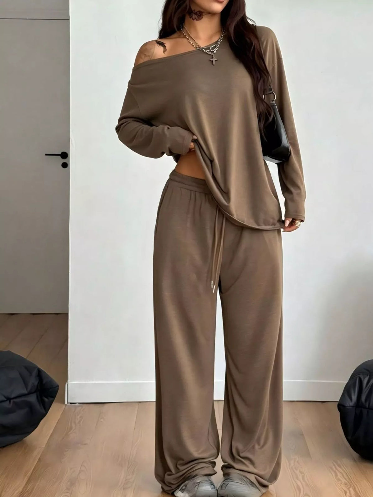 Plus size loose fit one-shoulder T-shirt and pants matching set by Trendsi, featuring a relaxed fit and stylish design.