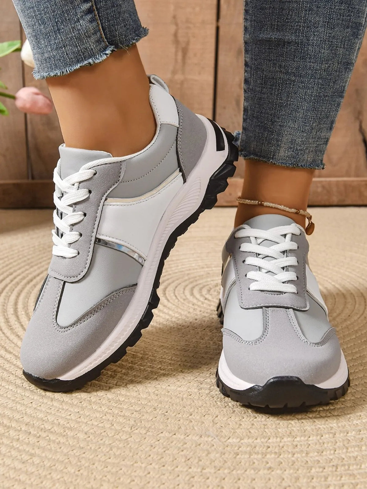 Black contrast lace-up sneakers with white soles, trendy footwear from Trendsi, shown on a clean background.