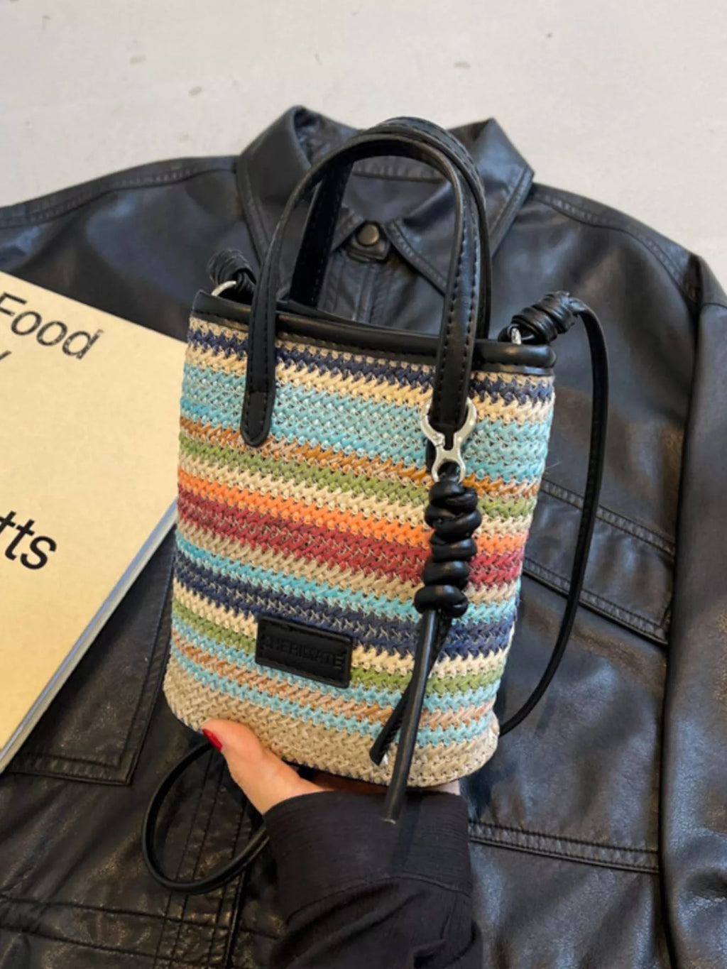 Striped woven mini crossbody bag with adjustable strap and zipper closure, featuring a trendy design from Trendsi.