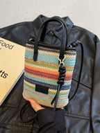Striped woven mini crossbody bag with adjustable strap and zipper closure, featuring a trendy design from Trendsi.