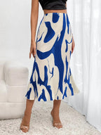 Women's zebra print pleated casual skirt with irregular hem and side slit, by FitiqueFit, shown in a stylish, flowing design.