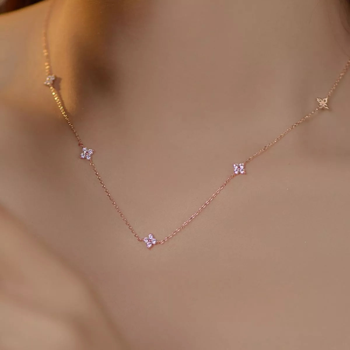 Sterling silver clover charm necklace with delicate chain, featuring a four-leaf clover pendant, from Plush Fashion Hub.